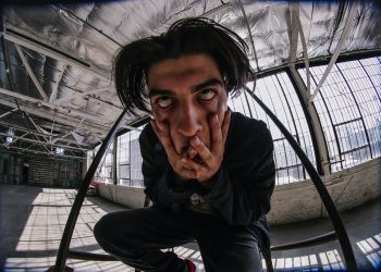 man in black jacket sitting on chair