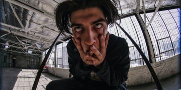 man in black jacket sitting on chair