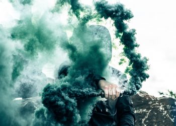 person holding gas grenade