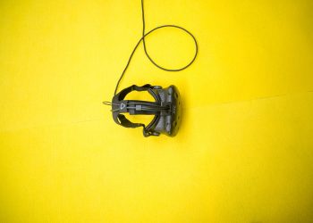 black VR smartphone headset on yellow surface