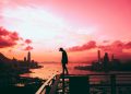 silhouette of person standing on railing